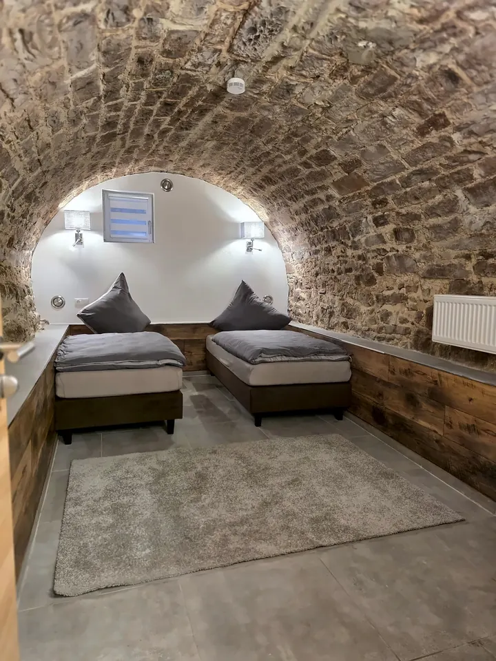 Schlafzimmer unter einem Gewölbe aus Bruchstein